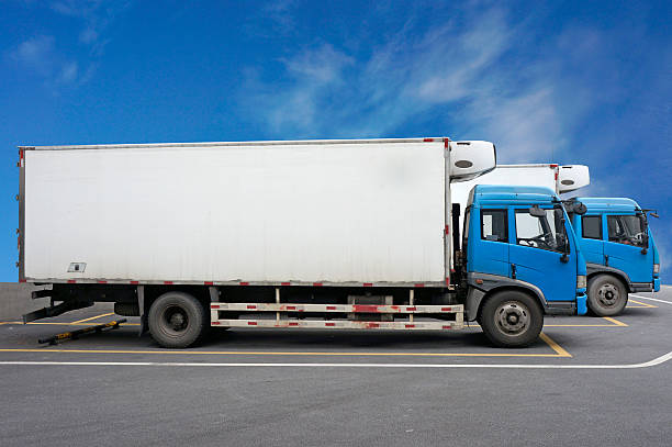 Vans at parking lot over blue sky.